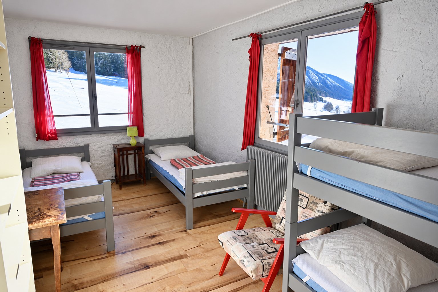 Chambre de montagne avec lits simples et lits superposés gris