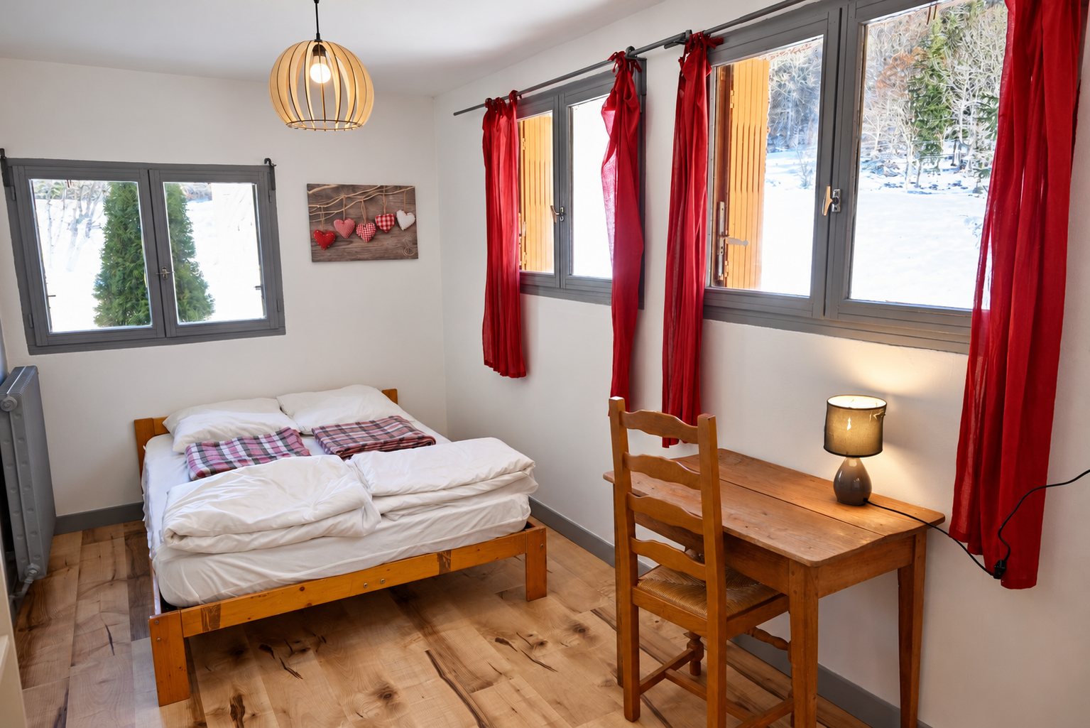 Chambre rustique avec lit double, bureau en bois et rideaux rouges